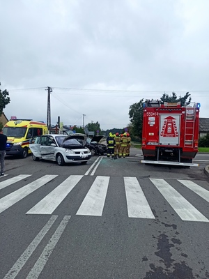 Zdjęcie przedstawia miejsce zderzenia pojazdów oraz pojazdy służb zabezpieczających- widok od ulicy Pocztowej